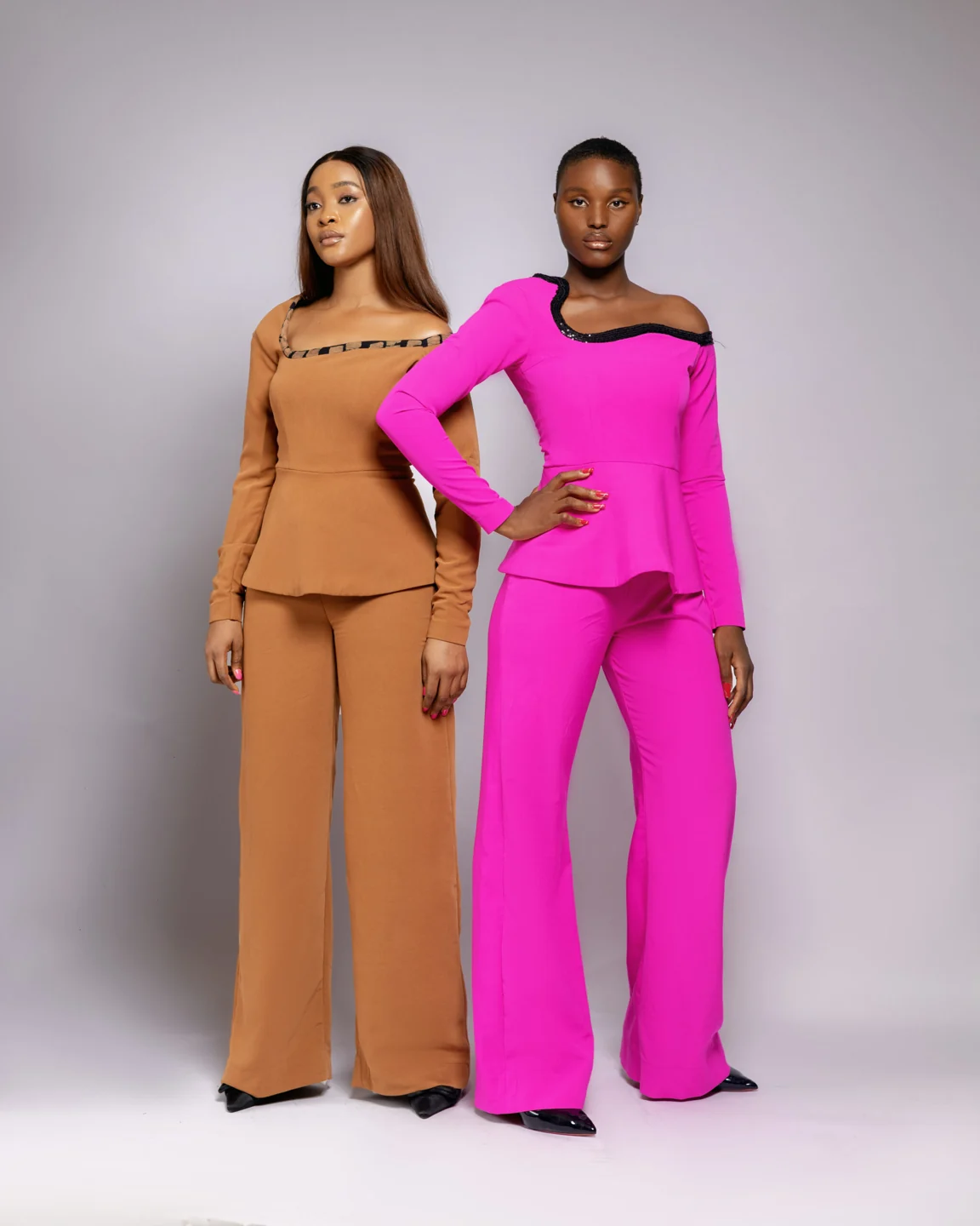 Models wearing camel and bright pink tailored outfits from Adeysoile